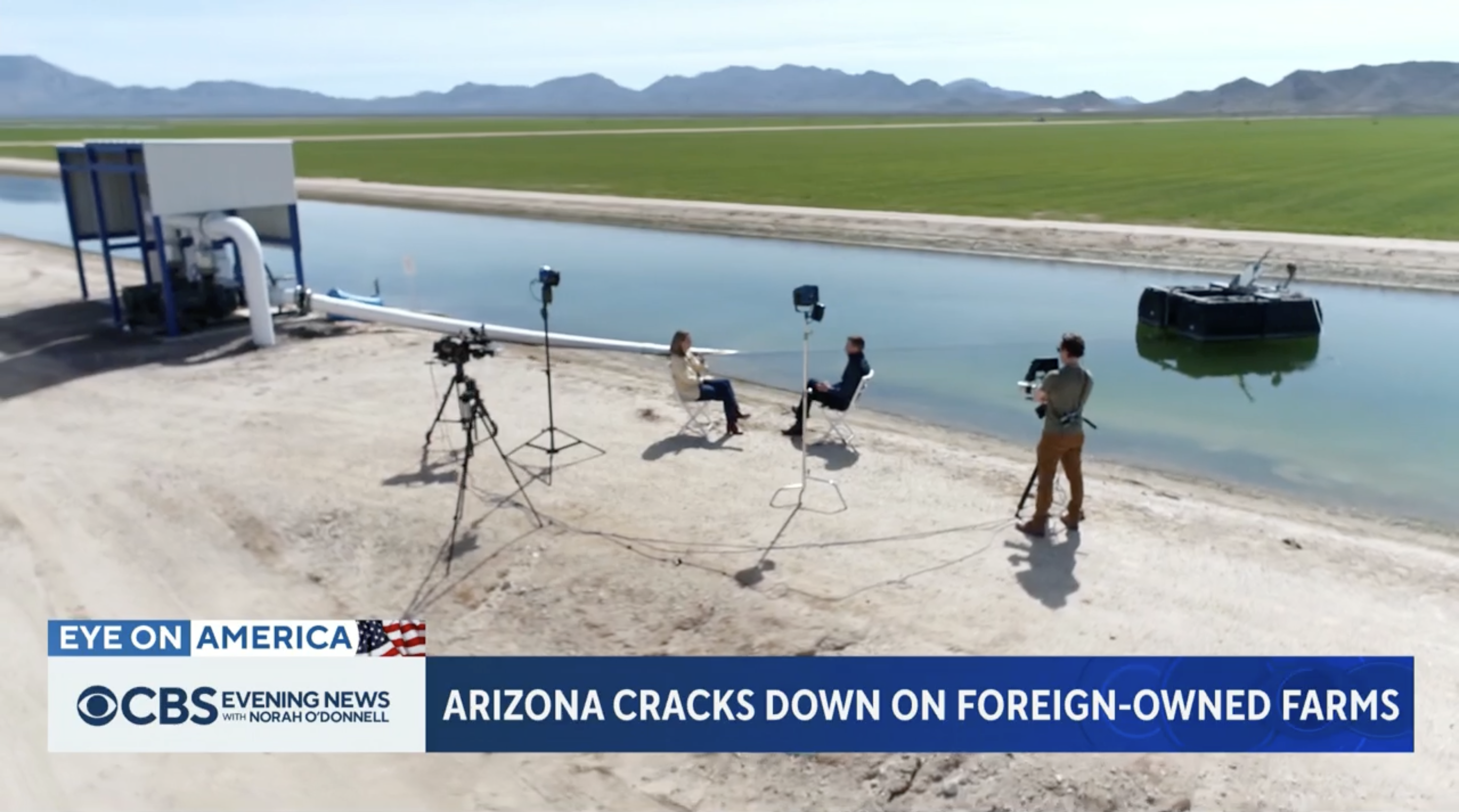 News crew interviewing Kris Mayes near a canal