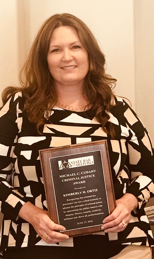 Kimberly Ortiz holding an award.