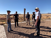 Law enforcement standing, talking during a training exercise.