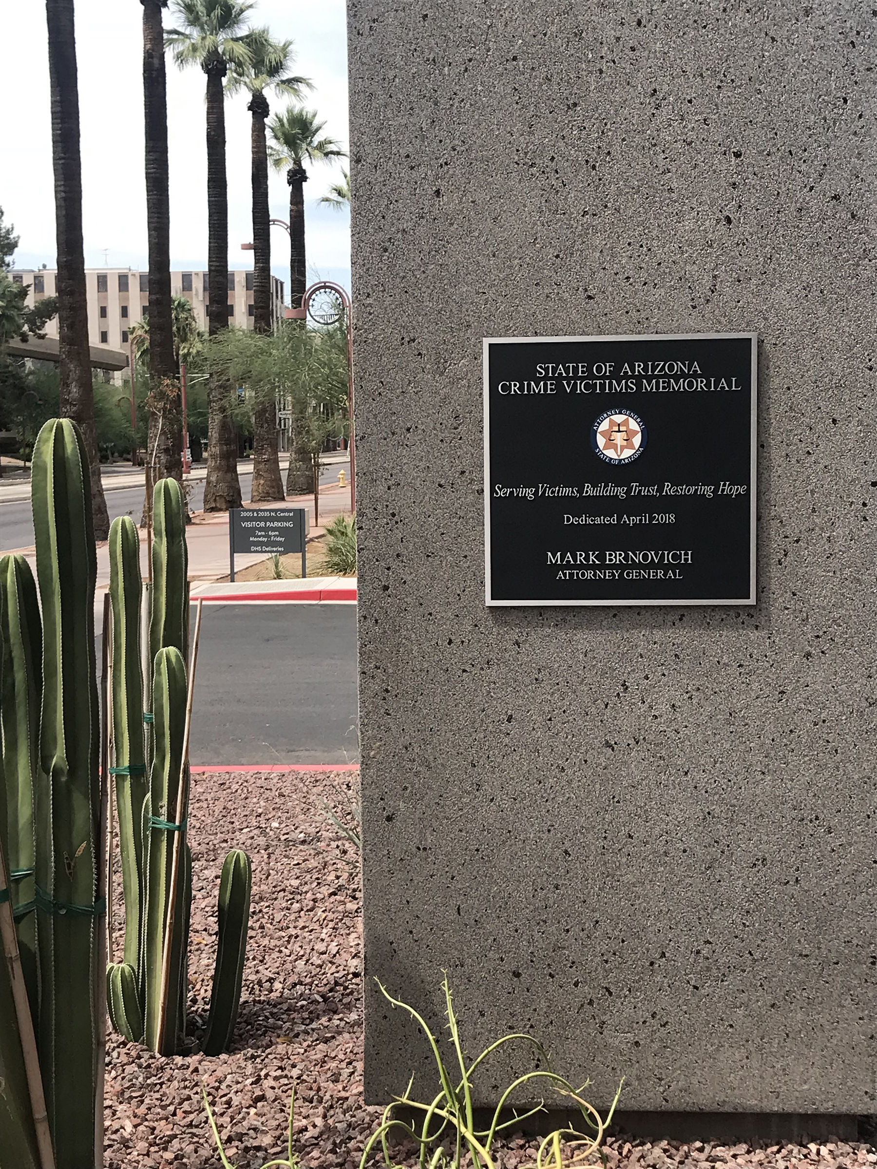 Desert landscape with plaque featured on the side of a building